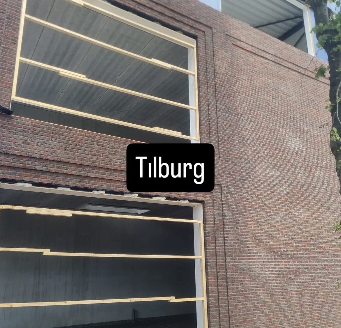 Aanbouw in Tilburg met deels afgerond nieuw gevelmetselwerk naast nog in voorbereiding zijnde kozijnopeningen